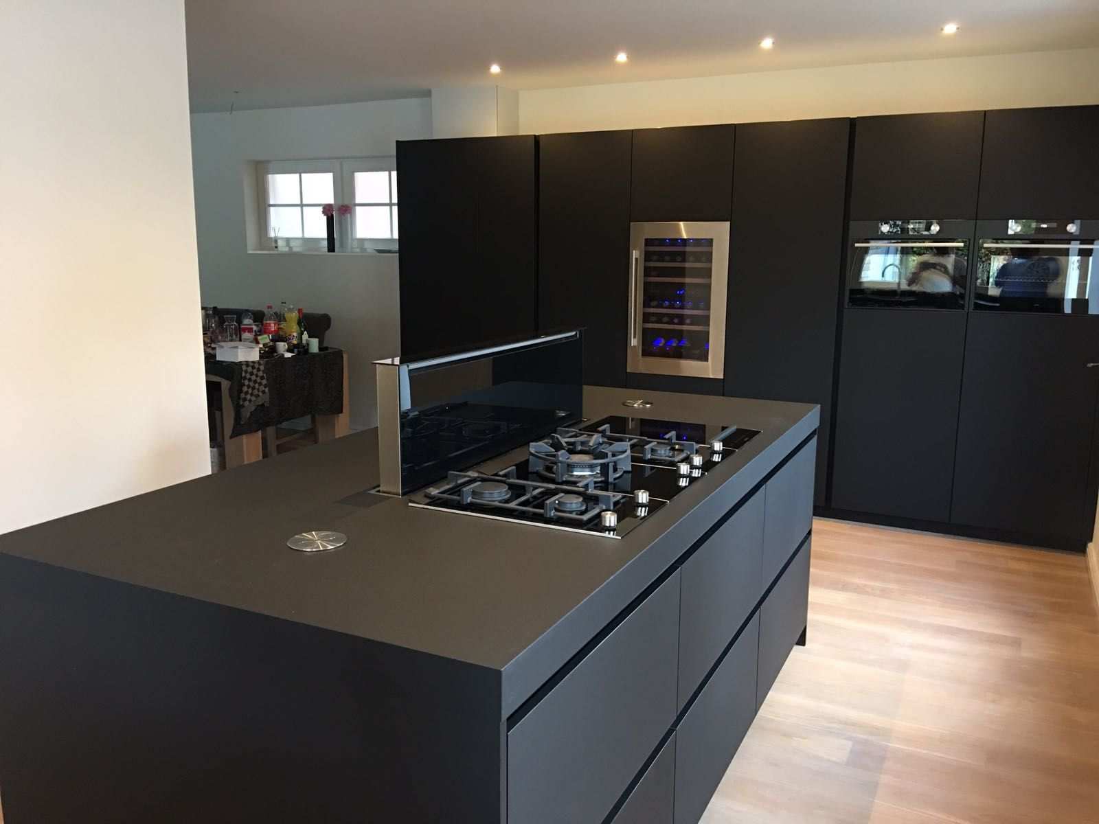 Modern Kitchen With High Gloss Black Cabinets And Wood Butcher