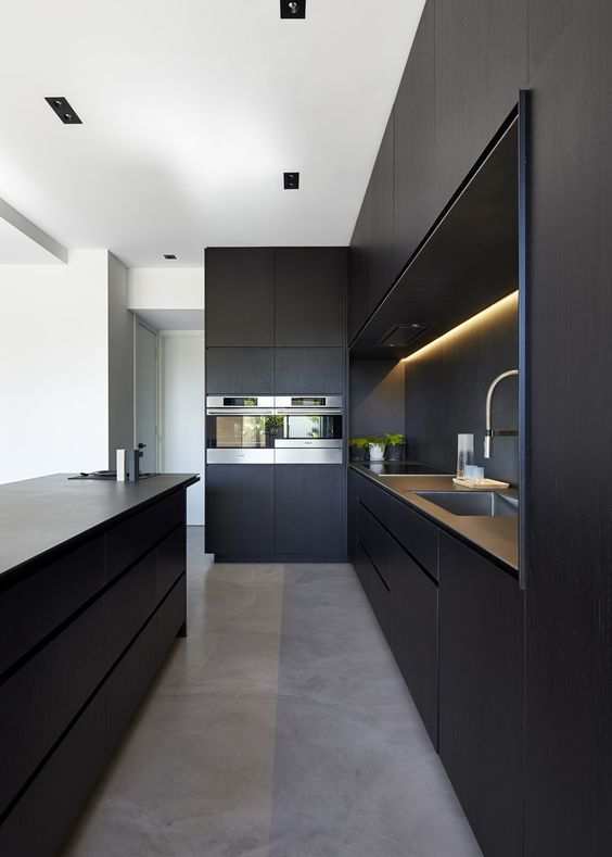 Modern Kitchen With High Gloss Black Cabinets And Wood Butcher